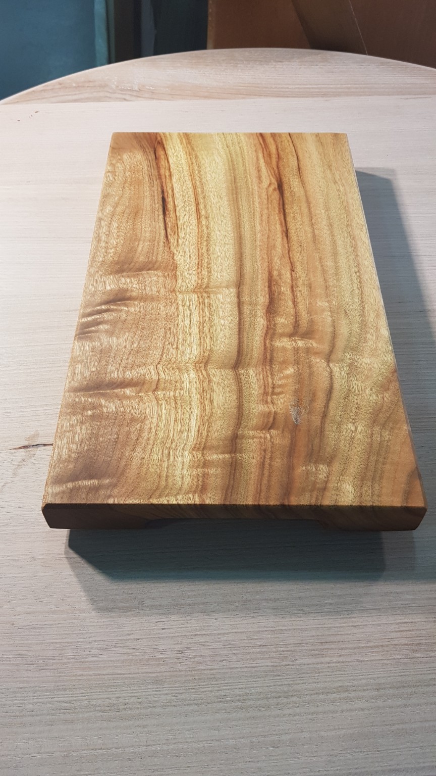 Finished timber cutting board with golden tones and distinctive grain