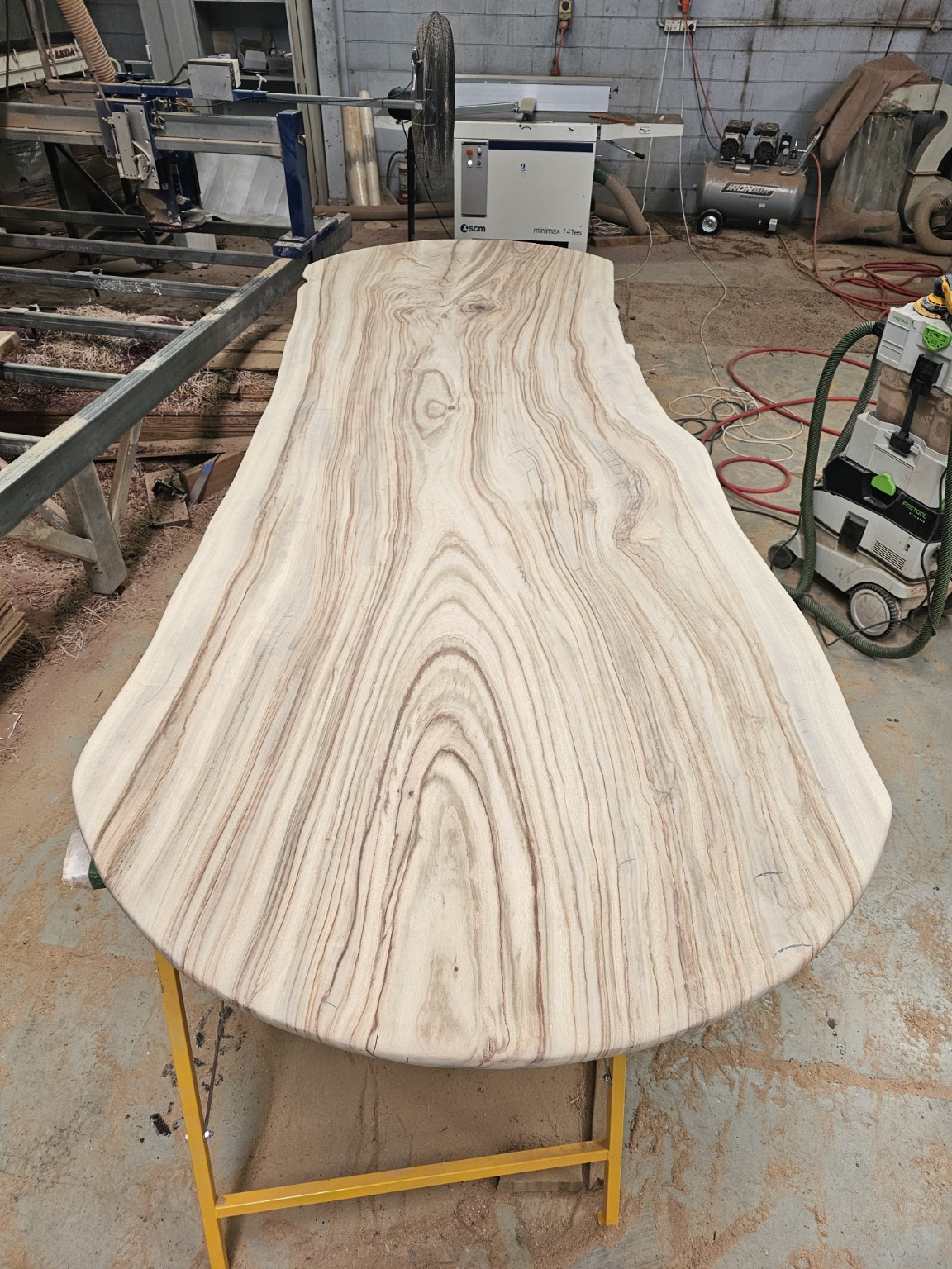 A shaped timber slab in the workshop
